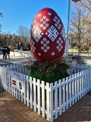 a large red ball sitting on top of a white fence at Vila Šventoji in Šventoji