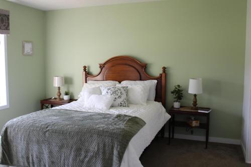 a bedroom with a large bed with white sheets and pillows at Stony Lane Retreat in Clare