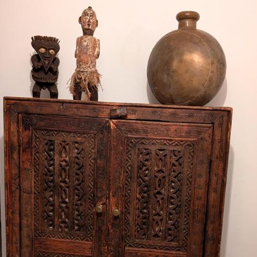 an old wooden cabinet with a vase and a statue at Dar Ettaki Workation Riad Cité Portugaise Mazagan in El Jadida