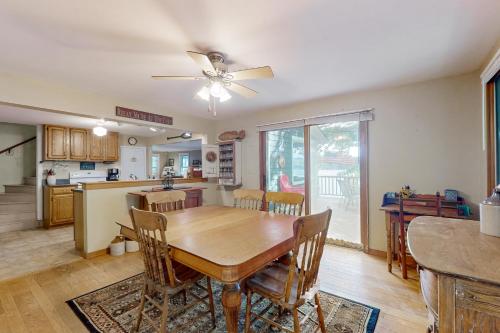 a dining room and kitchen with a table and chairs at Bomoseen Fever in Bomoseen