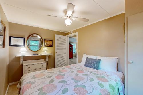 a bedroom with a bed and a ceiling fan at Bomoseen Fever in Bomoseen
