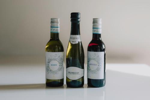 three bottles of wine sitting next to each other at Cavour Luxury Apartments in Verona