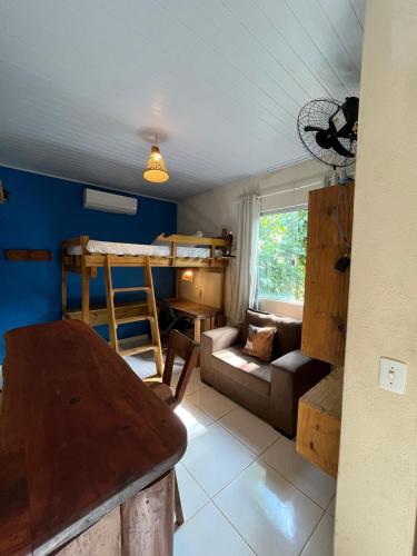 a living room with a bunk bed and a couch at Villa Residencial Encantos Da Mata in Itacaré