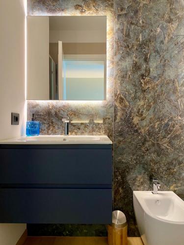 a bathroom with a sink and a mirror at Susanna Alloggio Turistico in Trissino