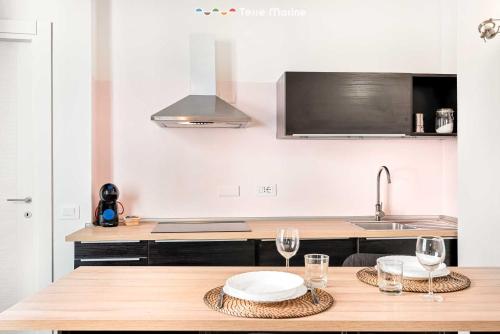 a kitchen with a table with glasses and a sink at Il Palombaro in Riomaggiore