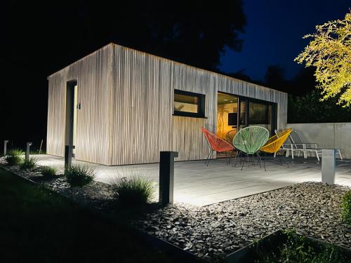 a small building with a table and chairs on a deck at Pool House 85 in Spa