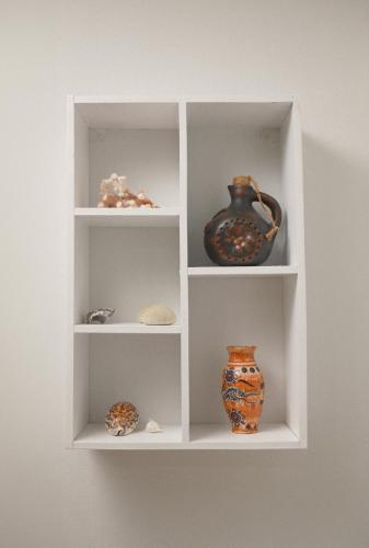 a white shelf with vases and vases on it at Sunset beach villa 7 O3 villas in Haad Pleayleam