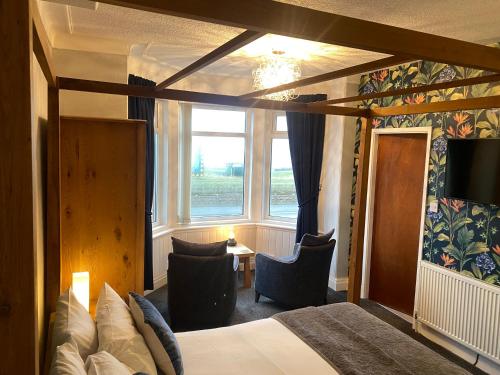 a hotel room with a bed and a window at The Fossil Tree Hotel in Blackpool