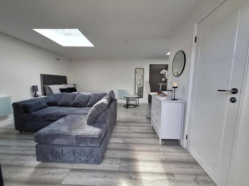 a living room with a couch and a table at Lodge - Sleeps 2 - Pet friendly - Parking - Patio in Sidcup