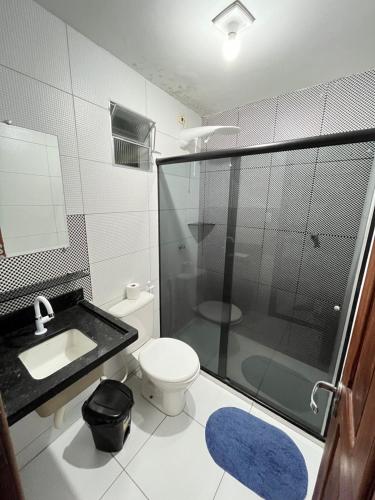 a bathroom with a shower and a toilet and a sink at Paraíso Olindense in Olinda