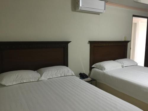 En eller flere senger på et rom på Hotel Lleras - Aparthotel