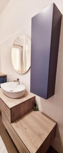 a bathroom with a sink and a mirror at Moi Moi B&B in LʼAquila