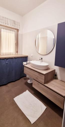a bathroom with a sink and a mirror at Moi Moi B&B in LʼAquila