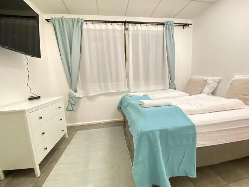 a small bedroom with a bed and a tv at Lux and Big Apartment in Walldorf