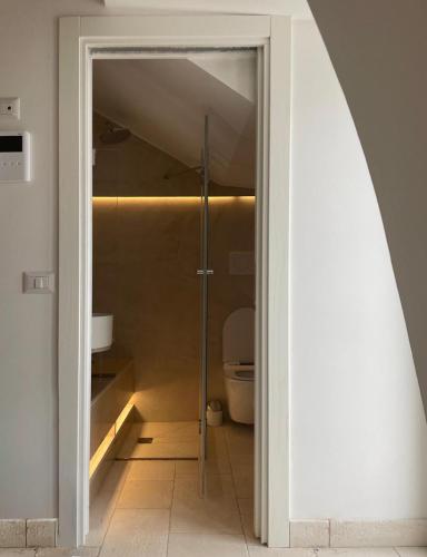 a bathroom with a shower and a toilet in it at Mazzini 5 in Locorotondo