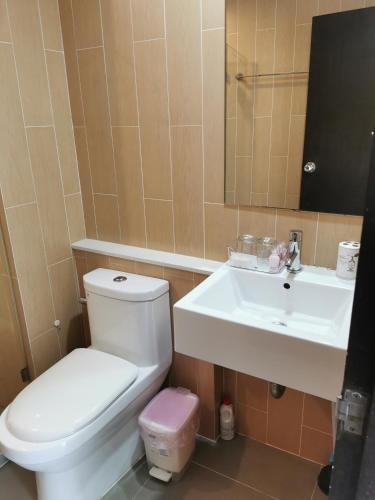 a bathroom with a toilet and a sink at Centrio Phuket C3 in Ban Rangeng