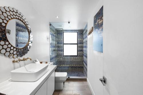 a bathroom with a sink and a toilet and a mirror at The Waterhouse- Amazing Villa With Infinity Pool in Miami