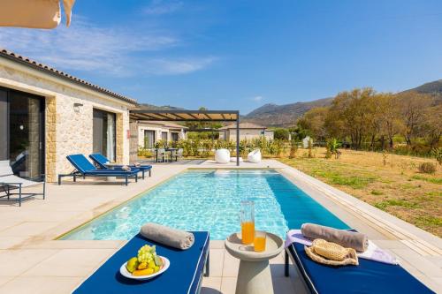 a villa with a swimming pool and a patio at Villa Margarita in Katelios