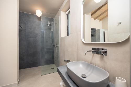 a bathroom with a sink and a shower at Villa Margarita in Katelios