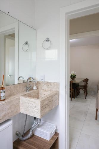 a bathroom with a sink and a mirror at Blackout suite • sleeps 5 in Bombas