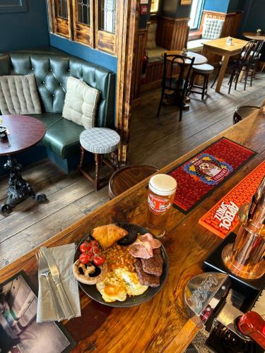 a table with a plate of breakfast food on it at The Rhu Inn in Rhu
