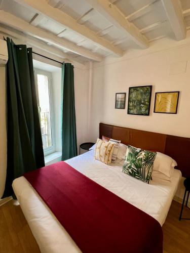 a bedroom with a large bed with green curtains at Charming Navona in Rome