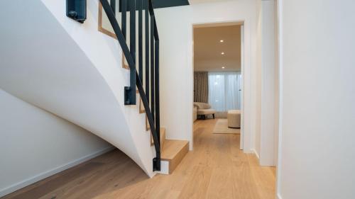 a hallway with a staircase in a house at Apartments Hotel Stadt Hamburg in Westerland (Sylt)