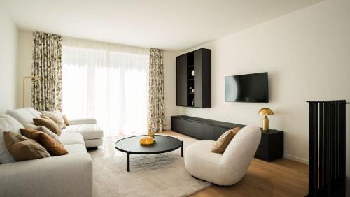 a living room with a couch and a table at Apartments Hotel Stadt Hamburg in Westerland (Sylt)
