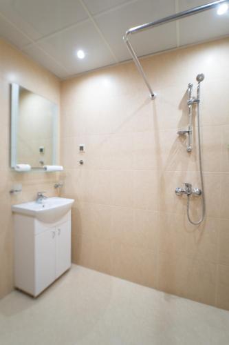 a bathroom with a sink and a shower at Апартамент АВА in Sandanski