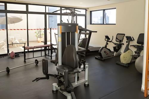 a gym with treadmills and exercise equipment in a room at Lindo flat na Sena Madureira! (Apto 1305) in Sao Paulo