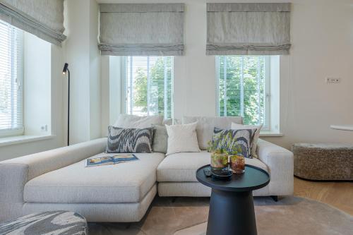 a living room with a couch and a table at Apartments Hotel Stadt Hamburg in Westerland (Sylt)