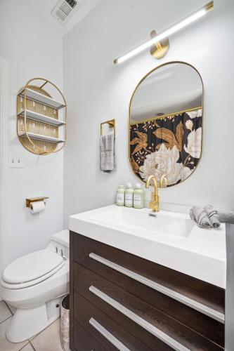 a bathroom with a sink and a mirror at Wrigley 2BR, 1BA with Free Parking in Chicago