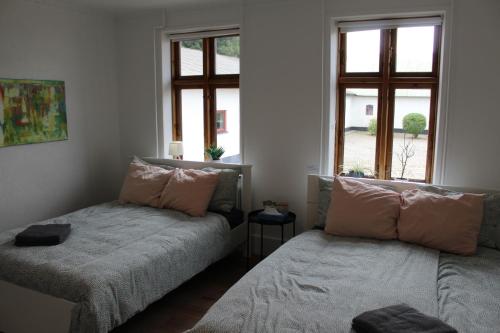 a living room with two beds and a window at STAY Billund in Vandel