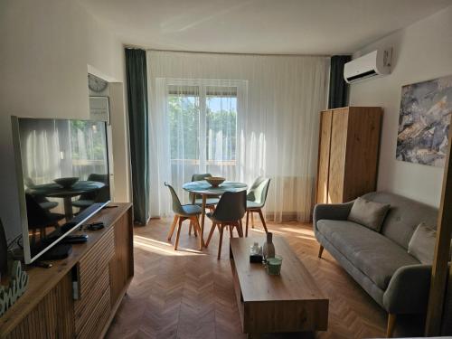 a living room with a couch and a table at D422Apartman in Dunaújváros