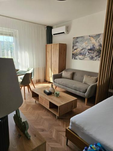 a living room with a couch and a coffee table at D422Apartman in Dunaújváros