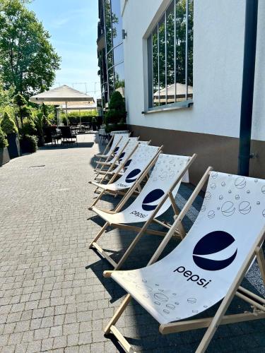a row of lounge chairs lined up against a building at Bursztynowa in Łuków
