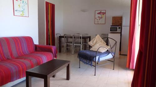 a living room with a couch and a table at Résidence les Hameaux de Bocca del Oro in Porto-Vecchio