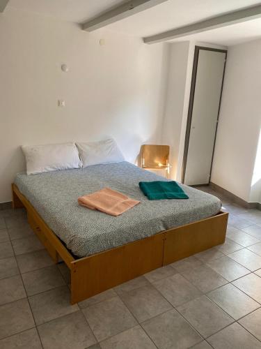 a bedroom with a bed with two towels on it at Davesco Court Apartment in Cadro