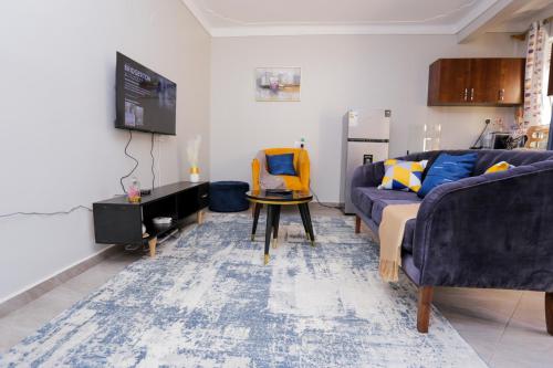 a living room with a couch and a table at Yo House Muyenga in Muyenga 