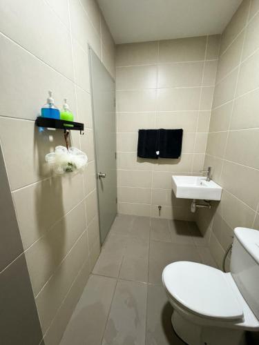 a bathroom with a toilet and a sink at Palmera Residence Cozy Condo in Kajang