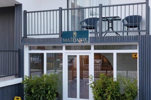 a building with a sign that reads nazaniamine at Hotel Mažijanik in Nikšić