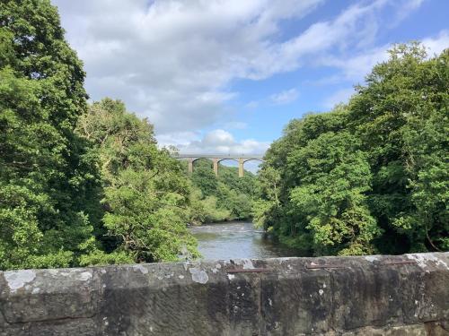 a river with a bridge in the background at Aqueduct apartment near Llangollen in Llangollen
