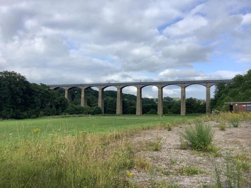 a viaduct over a green field with a cloudy sky at Aqueduct apartment near Llangollen in Llangollen