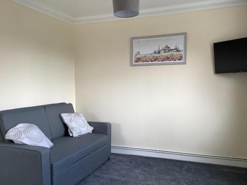 a living room with a couch and a picture on the wall at Aqueduct apartment near Llangollen in Llangollen