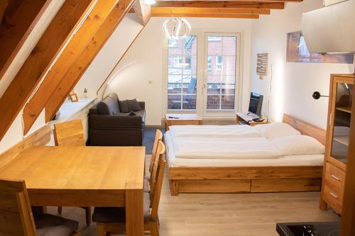 a small room with a bed and a table at Appartement Achtern Diek 2-23 in Dorum-Neufeld
