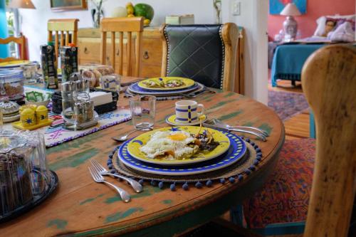 a wooden table with a plate of food on it at Casa Itzae B&B Polanquito Dog Friendly in Mexico City