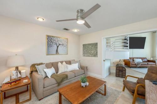 a living room with a couch and a table at FEATURED ON HGTV'S MY LOTTERY DREAM HOME! Private dock, 15 minute boat ride to Crab Island, 20 minute drive to Destin, Pet Friendly in Niceville