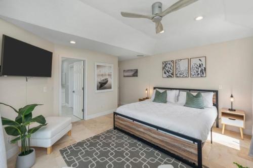 a bedroom with a bed and a flat screen tv at FEATURED ON HGTV'S MY LOTTERY DREAM HOME! Private dock, 15 minute boat ride to Crab Island, 20 minute drive to Destin, Pet Friendly in Niceville