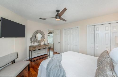 a bedroom with a bed and a ceiling fan at FEATURED ON HGTV'S MY LOTTERY DREAM HOME! Private dock, 15 minute boat ride to Crab Island, 20 minute drive to Destin, Pet Friendly in Niceville