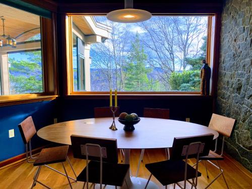 a dining room with a table and a large window at NewVida Preserve in Wilmington